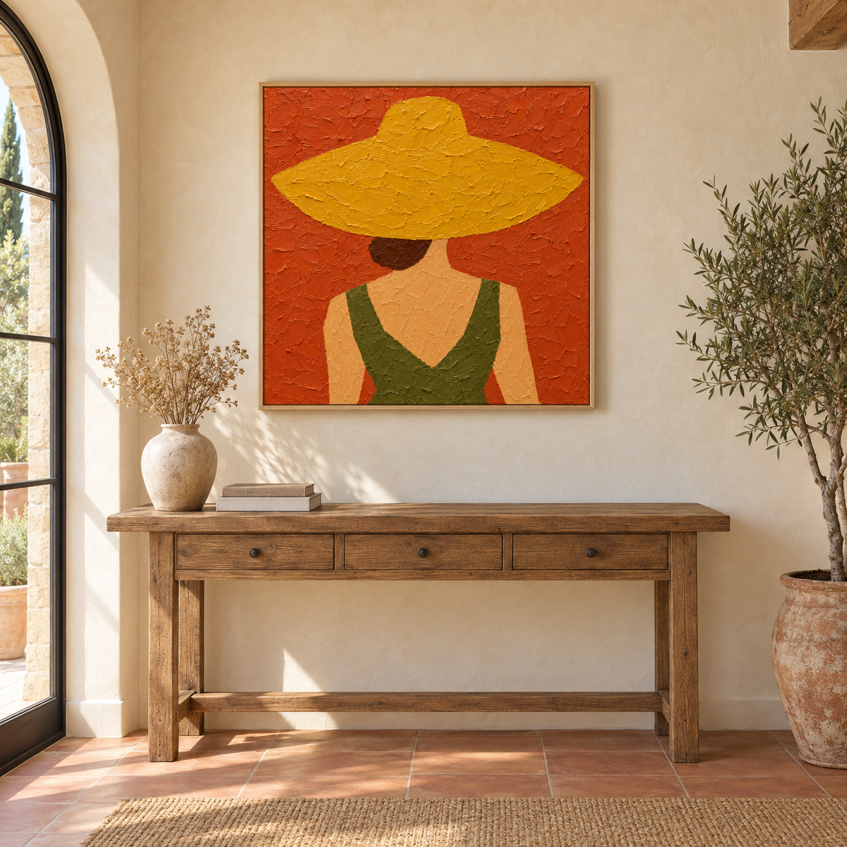 40x40 inch oil painting of a woman in an oversized straw hat seen from behind above a console table in a sunlit Mediterranean villa entryway